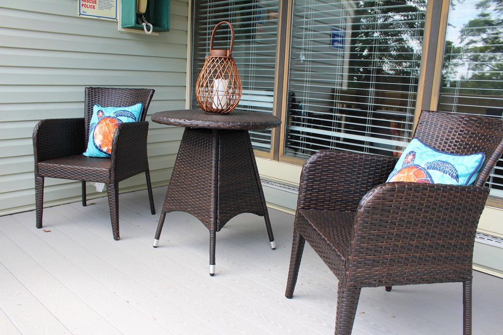 a group of chairs and a table on a porch  at Hunter's Creek Apartments, Cincinnati, Ohio