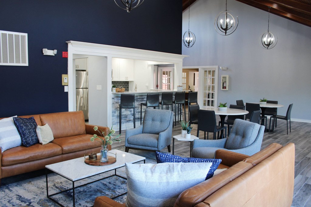 a living room with couches and chairs and a kitchen at Steeplechase Apartments, Loveland, 45140