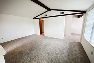 a bedroom with a carpeted floor and white walls