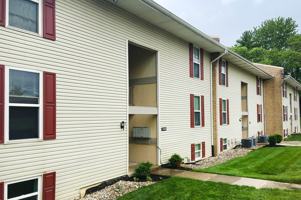 a side view of a white house with red doors at Timber Ridge Apartments, Ohio