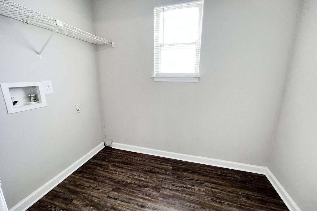 a small room with a wooden floor and a small window at 450 on Keeneland, Richmond