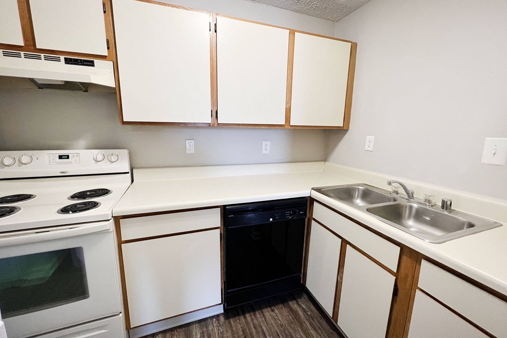a kitchen with white cabinets and a black dishwasher at 450 on Keeneland, Kentucky
