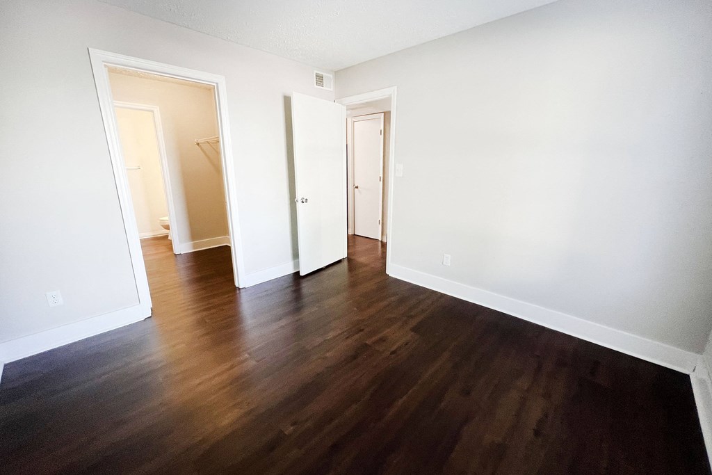 a bedroom with hardwood floors and white walls at 450 on Keeneland, Richmond, KY