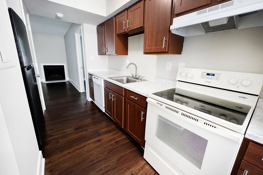 a kitchen with white appliances and wooden cabinets at 450 on Keeneland, Kentucky