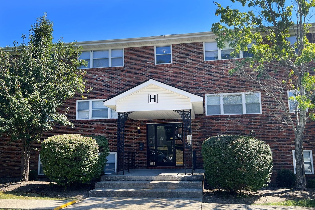 the front of a brick building with steps and a door at Park Place, Kentucky