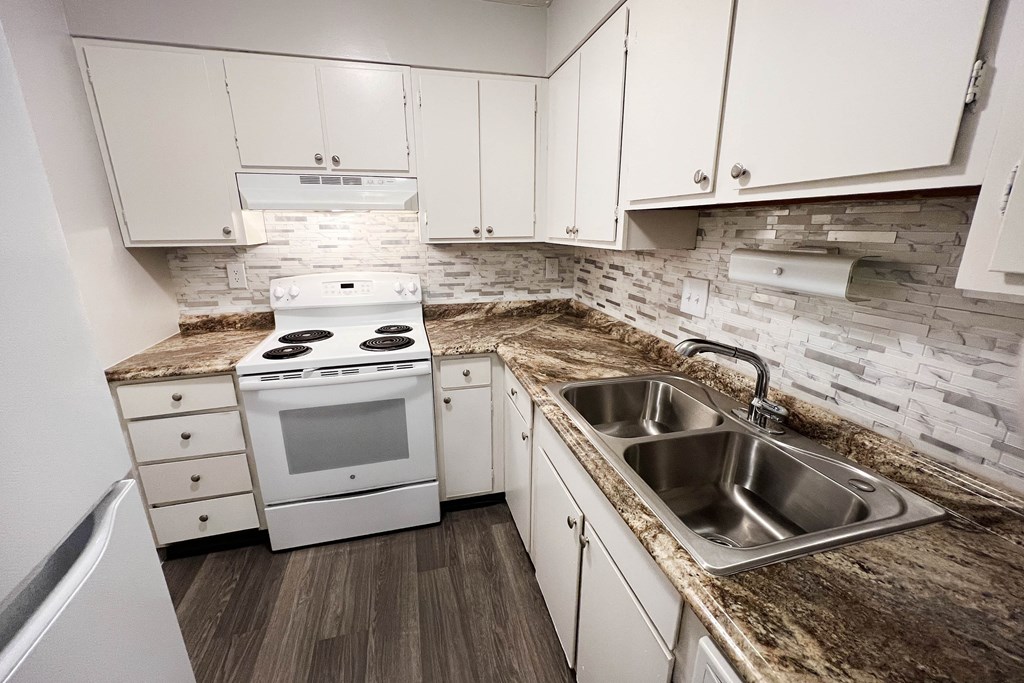 Kitchen with appliances and white cabinets at Oakwood Apartments, Florence