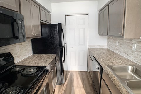a kitchen with stainless steel appliances and granite counter tops