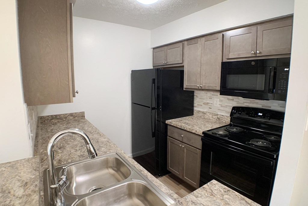 Updated Kitchen With Black Appliances at Steeplechase Apartments, Loveland