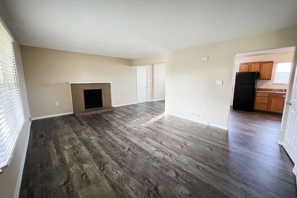an empty living room with wooden floors and a fireplace  at The Villas at Kingswood, Ohio, 45069