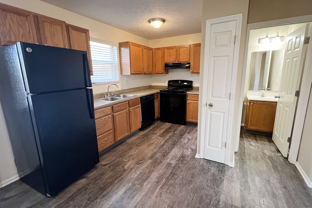 a kitchen with wood floors and a black refrigerator  at The Villas at Kingswood, West Chester, OH, 45069