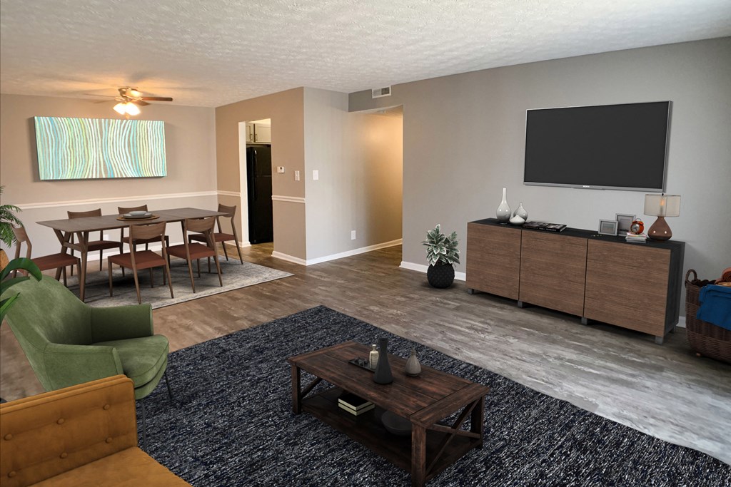 a living room with a tv and a table and chairs  at Knobs Pointe Apartments, Indiana