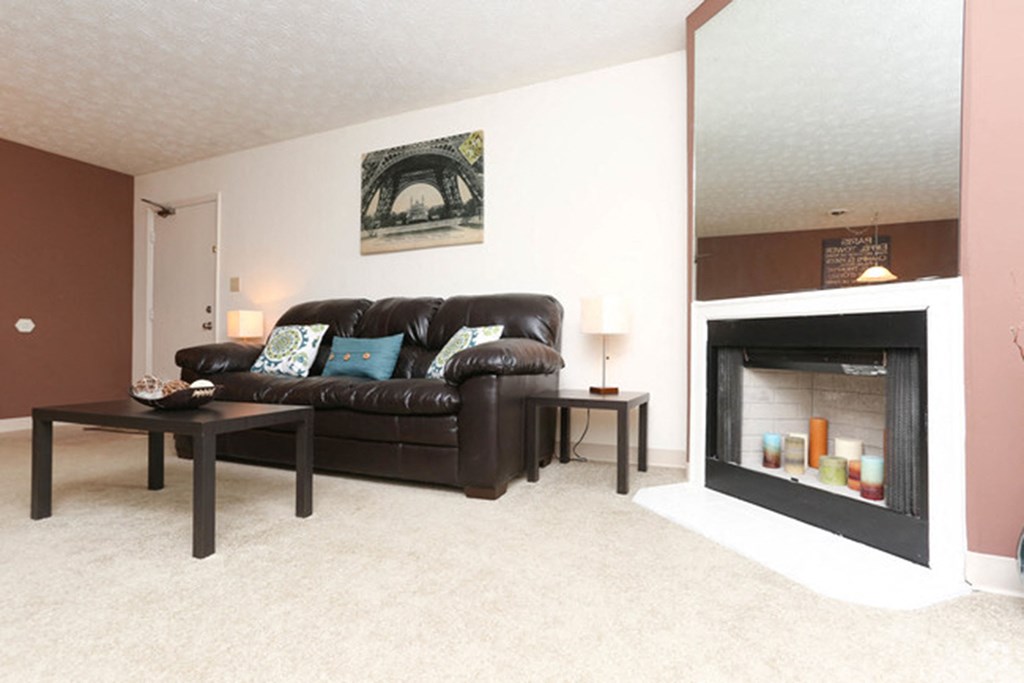 a living room with a leather couch and a fireplace at 450 on Keeneland, Richmond, 40475