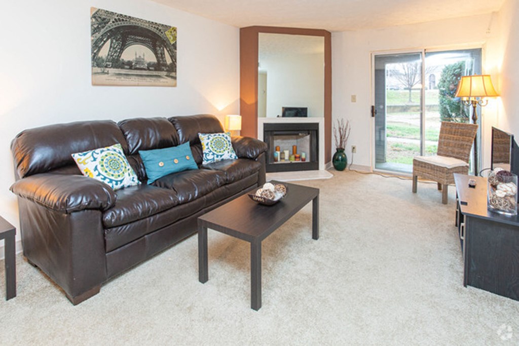 a living room with a leather couch and coffee table at 450 on Keeneland, Richmond, KY