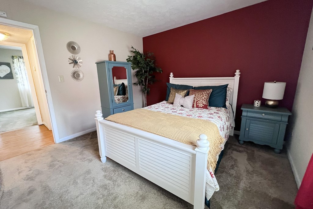 A bedroom with a white bed and a blue cabinet.