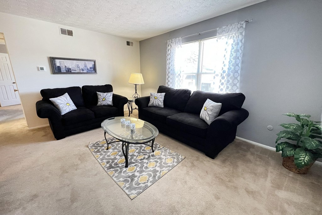 a living room with couches and a coffee tableat Revere Village Apartments, Centerville, Ohio