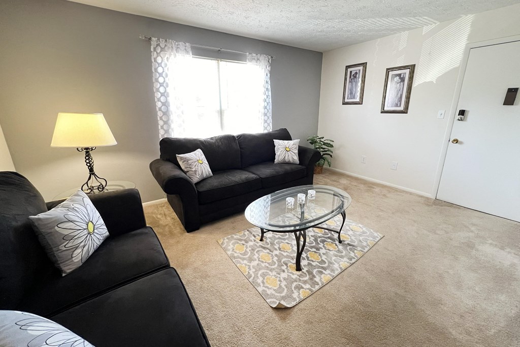 a living room with couches and a glass coffee tableat Revere Village Apartments, Centerville, 45458