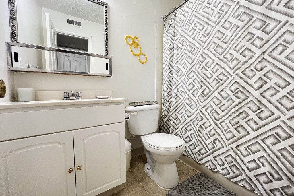a white bathroom with a shower and a toiletat Revere Village Apartments, Centerville, OH