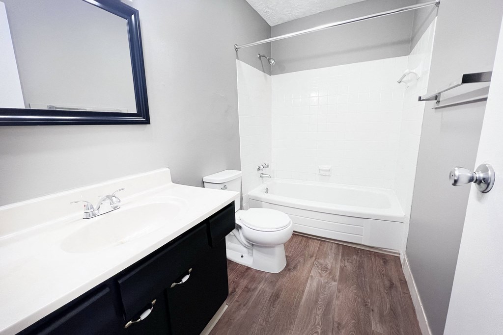A white sink and toilet in a small bathroom.
