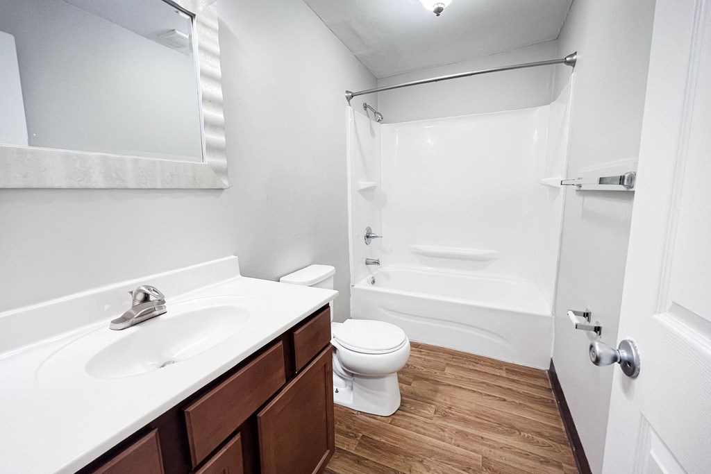 A white sink and toilet in a small bathroom.