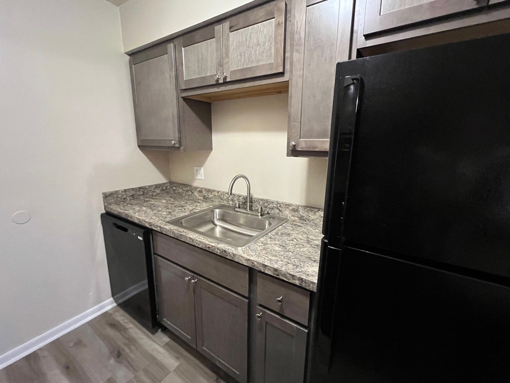 an empty kitchen with a sink and a refrigerator at Hunter Ridge Apartments, Cincinnati, OH, 45244