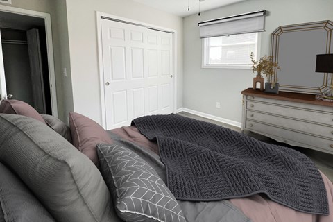 a bedroom with a bed with pillows and a dresser
