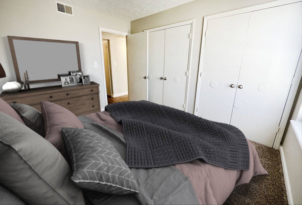 a bedroom with a bed and a dresser with a mirror on it at 450 on Keeneland, Kentucky