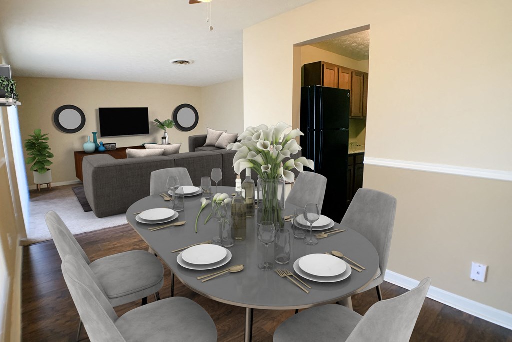 a dining room and living room with a table and chairs  at Timber Ridge Apartments, Ohio