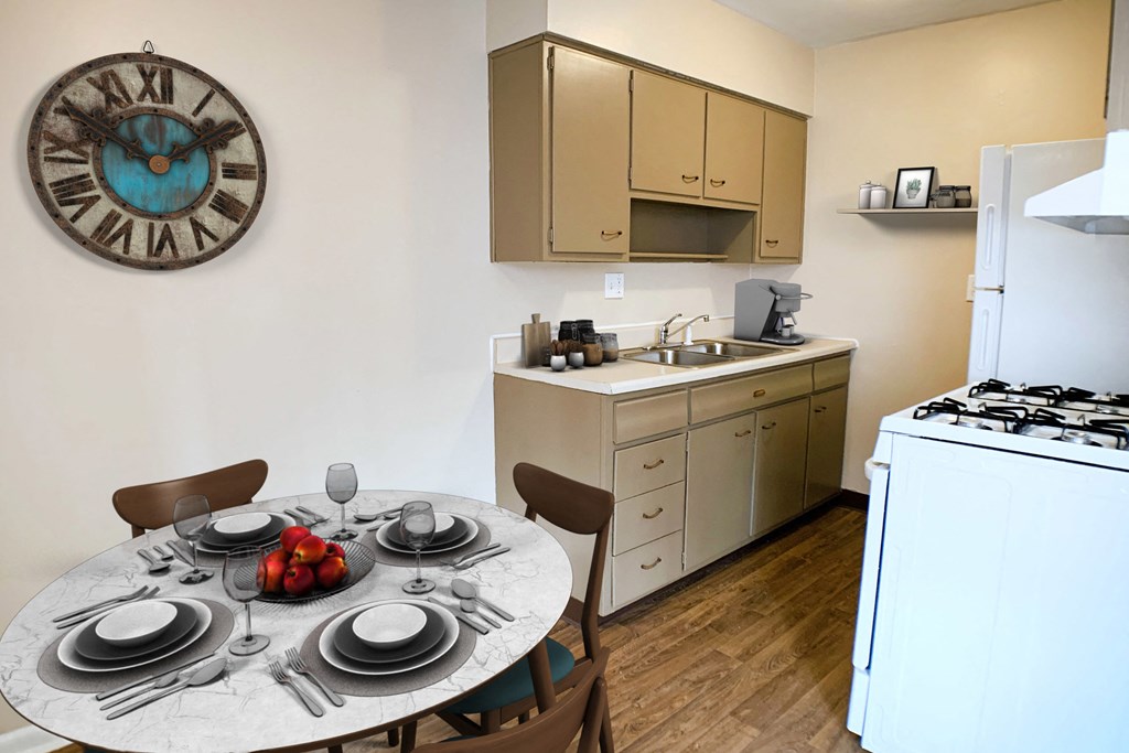 Kitchen with white appliances and dining at Sharondale Woods Apartments, Ohio