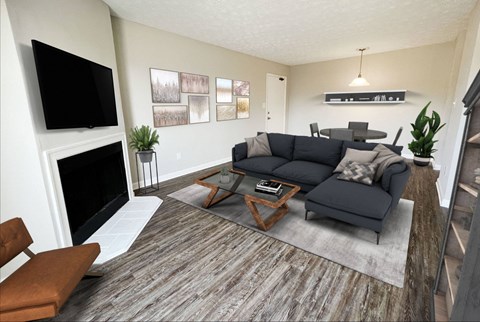 a living room with a couch and a coffee table in front of a fireplace