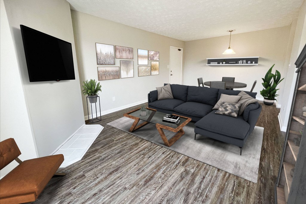 an open living room with a couch and a tv at 450 on Keeneland Apartments, Richmond, KY