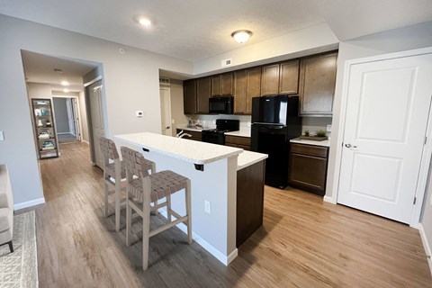 an open kitchen and dining area with a white counter top at Brookfield Village in Grove City