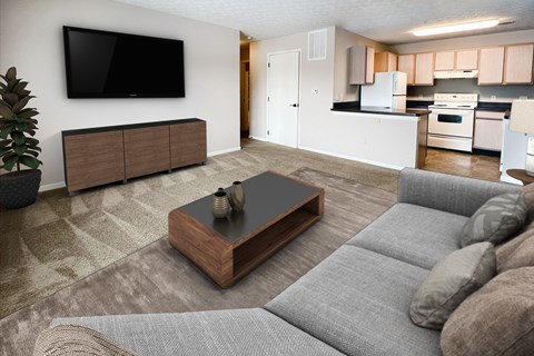 A living room with a grey couch and a wooden coffee table.