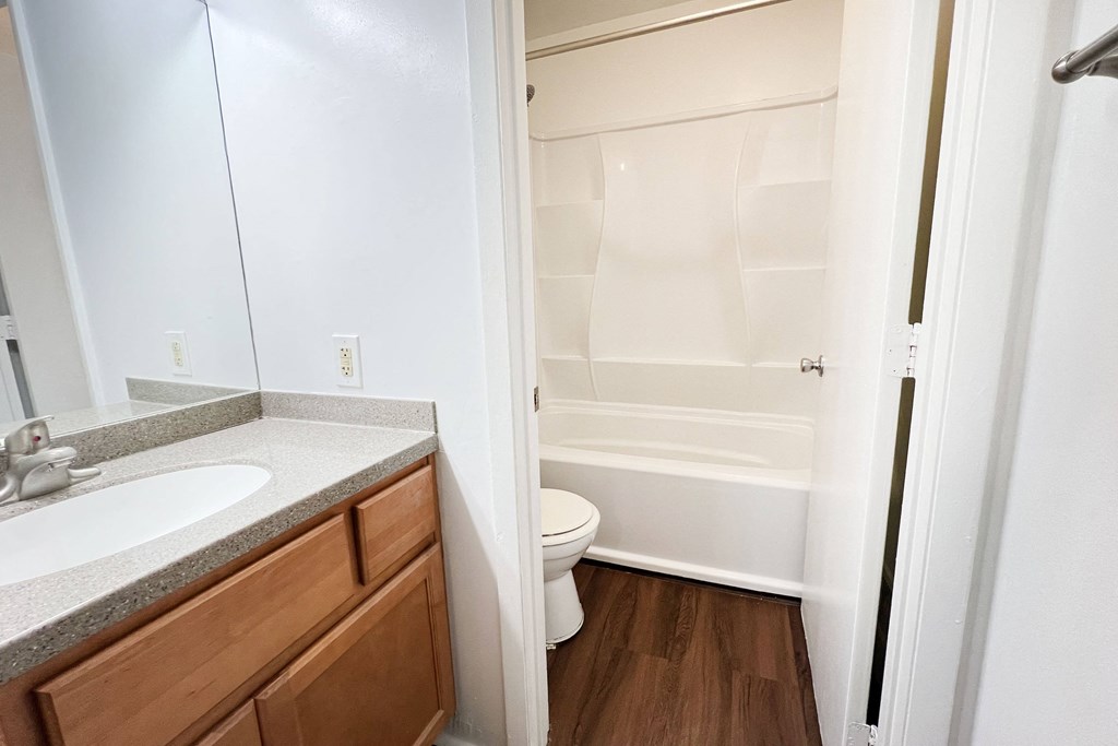 a bathroom with a sink toilet and shower and a mirror at Walnut Creek Townhomes, Cincinnati