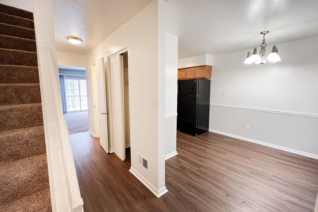 a renovated living room and kitchen with hard wood flooring and a staircase at Walnut Creek Townhomes, Cincinnati