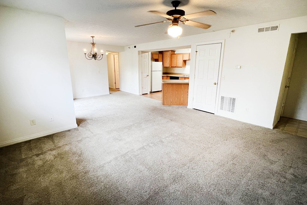 an empty living room with carpet and a ceiling fan  at Walton Ridge Apartments, Walton, Kentucky