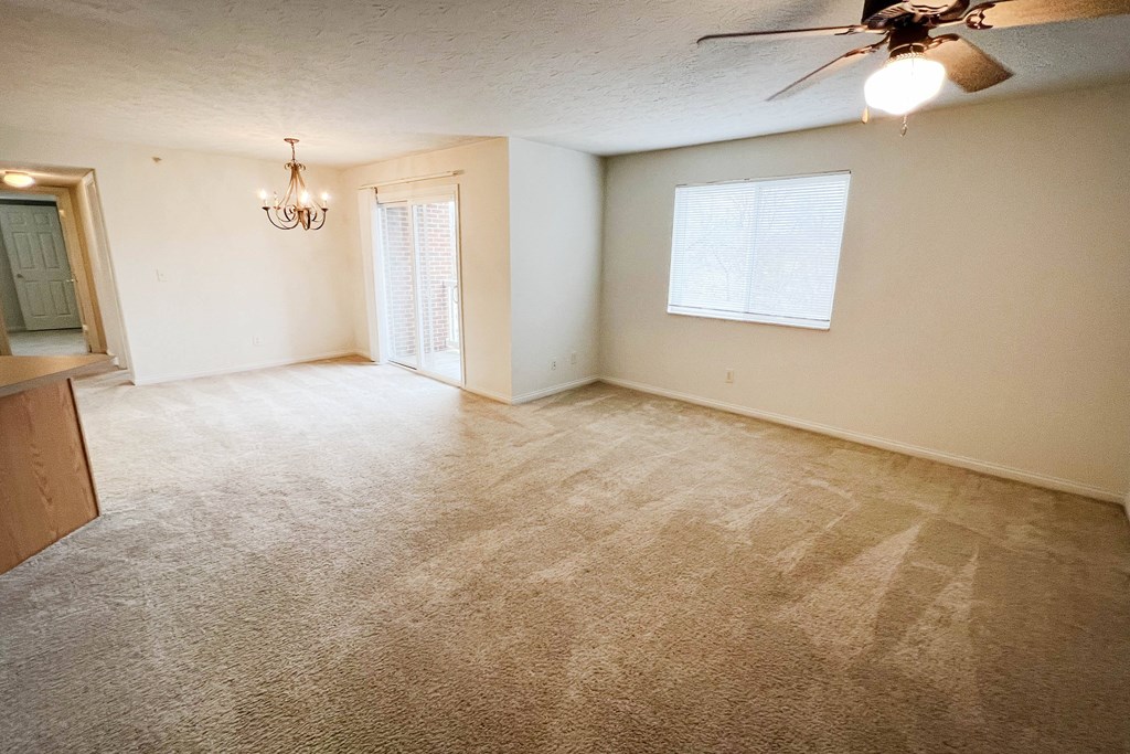 an empty living room with carpet and a ceiling fan  at Walton Ridge Apartments, Walton, KY