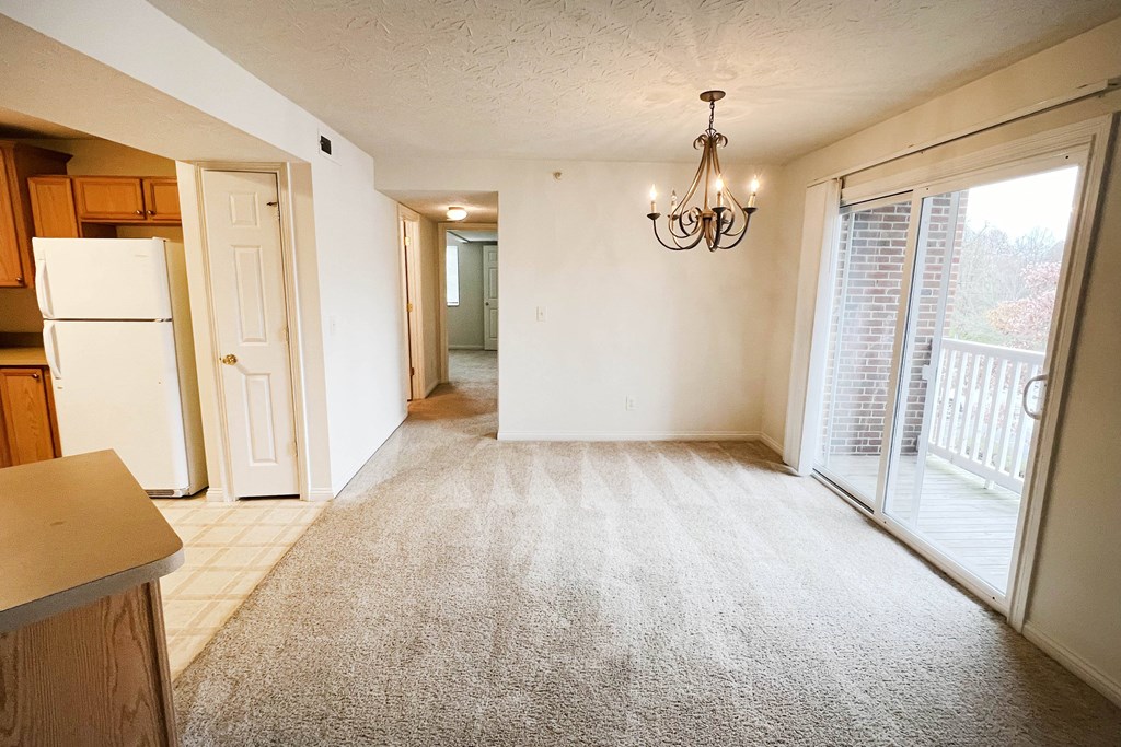 an empty kitchen and living room with a door to a balcony  at Walton Ridge Apartments, Kentucky, 41094