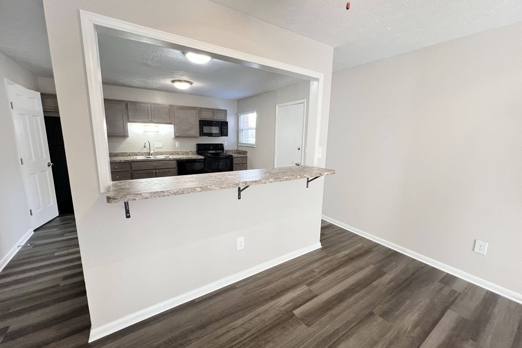 a view of a kitchen from a living room with a counter at Revere Village Apartments, Centerville, 45458