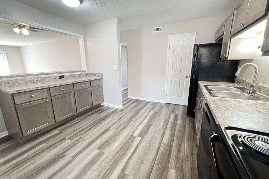 A kitchen with a black fridge and a sink at Revere Village Apartments, Ohio, 45458