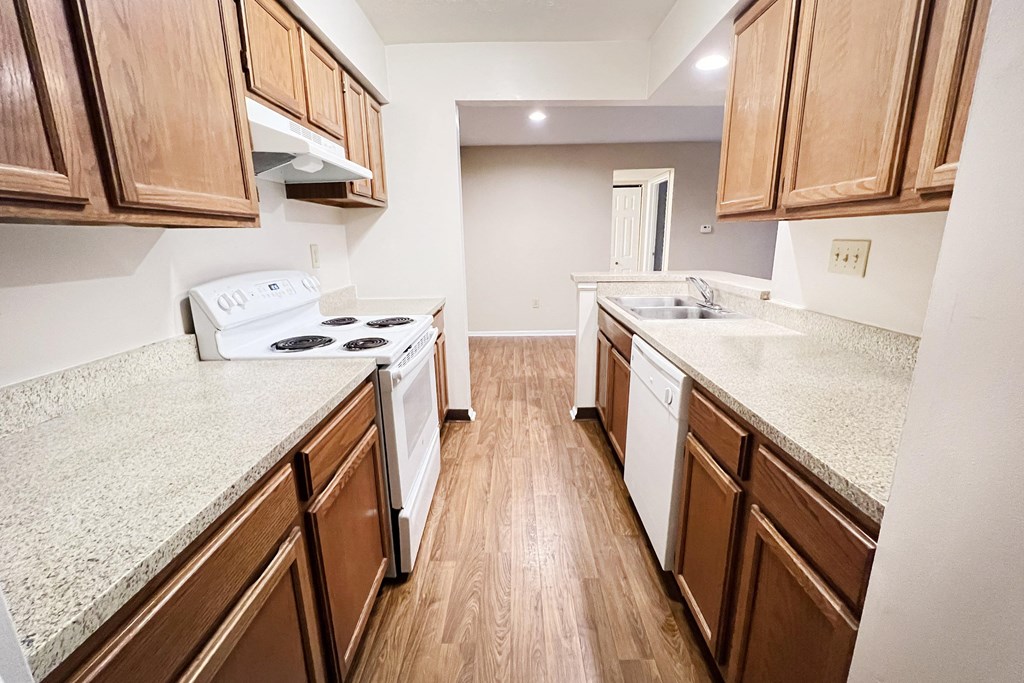 a kitchen with wood flooring and granite counter tops  at Deercross Apartments, Cincinnati, 45236