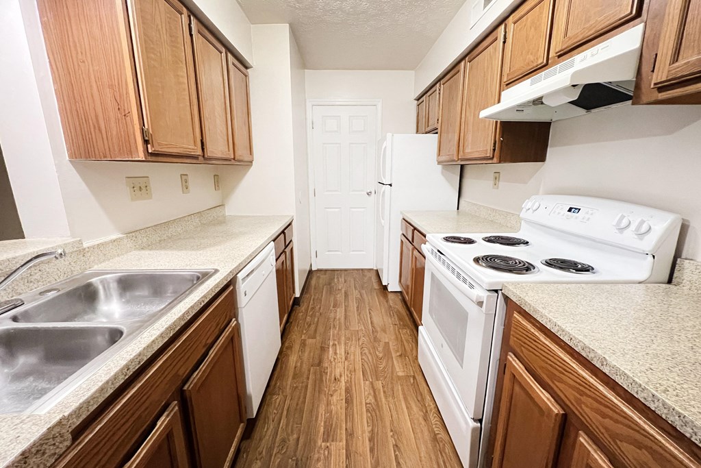 an empty kitchen with wood flooring and white appliances  at Deercross Apartments, Ohio, 45236