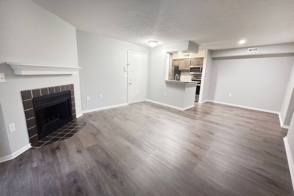a living room with a fireplace and wooden floors  at Deercross Apartments, Ohio, 45236