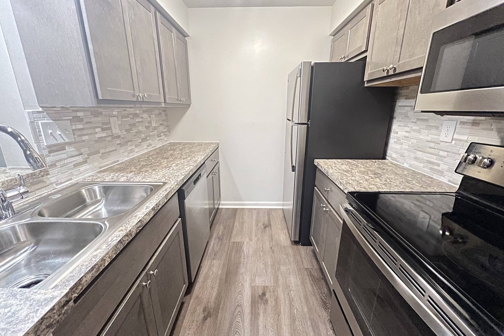 a kitchen with stainless steel appliances and marble counter tops  at Deercross Apartments, Cincinnati, OH, 45236