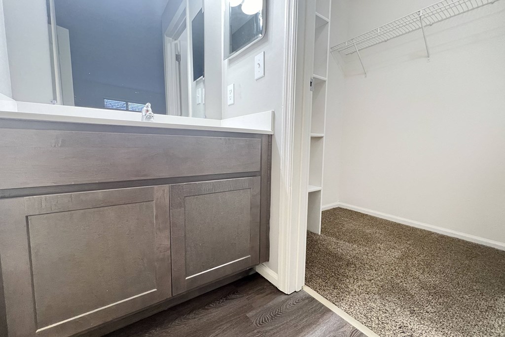 a bathroom with a vanity with a mirror and a sink  at Deercross Apartments, Cincinnati