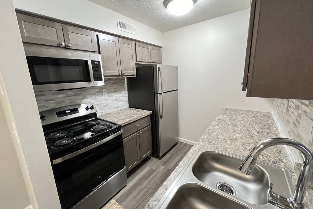 a kitchen with stainless steel appliances and granite counter tops  at Deercross Apartments, Ohio, 45236