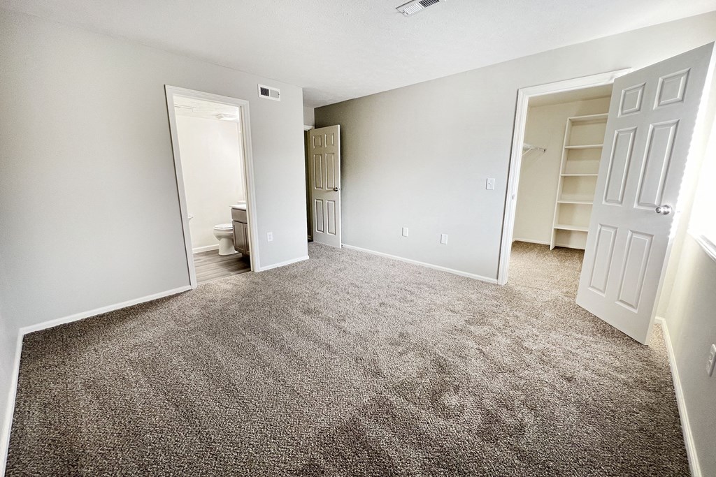an empty living room with carpet and a closet  at Deercross Apartments, Cincinnati, 45236