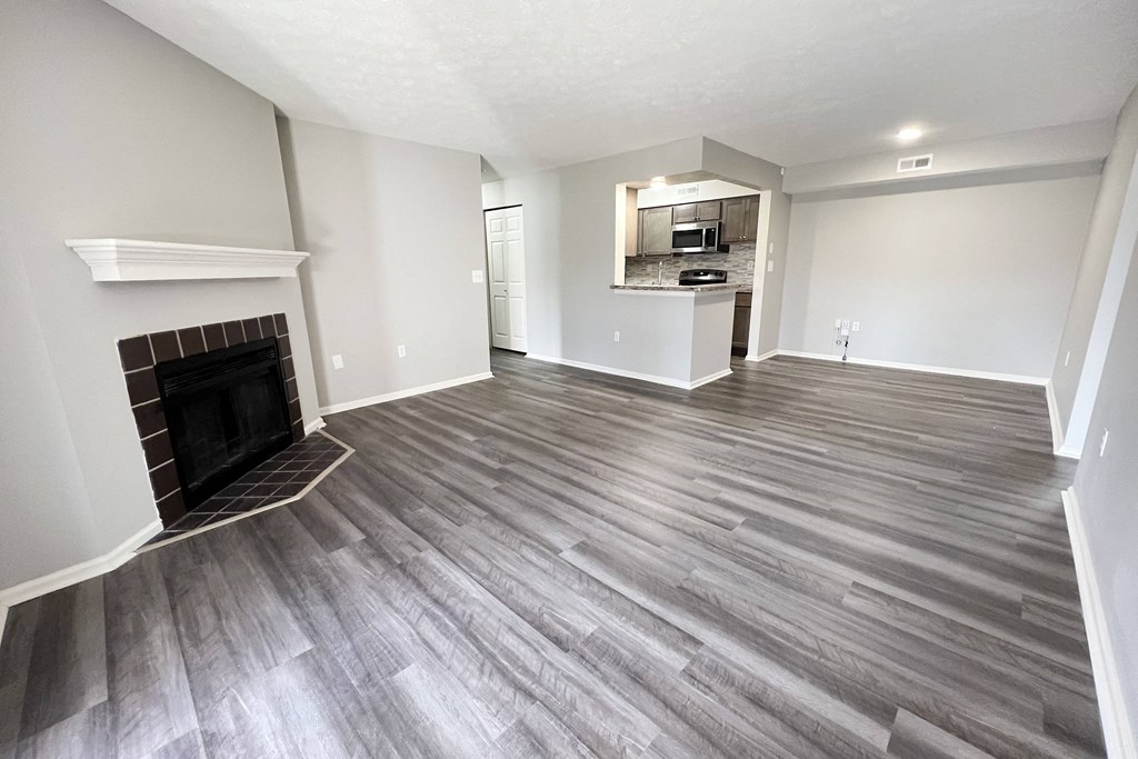 a living room with wood flooring and a fireplace  at Deercross Apartments, Ohio, 45236
