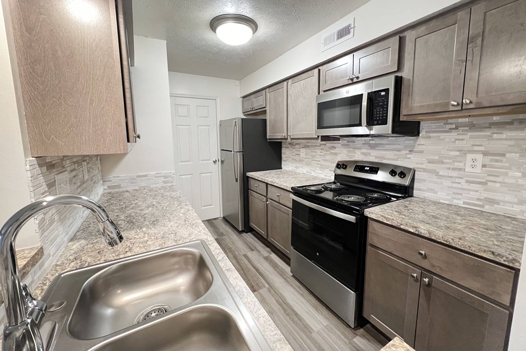 a kitchen with stainless steel appliances and granite counter tops  at Deercross Apartments, Cincinnati, OH, 45236