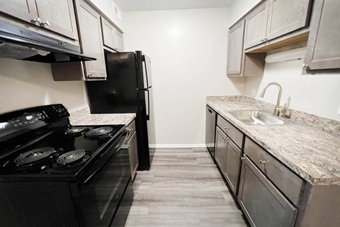 a kitchen with stainless steel appliances and marble counter tops