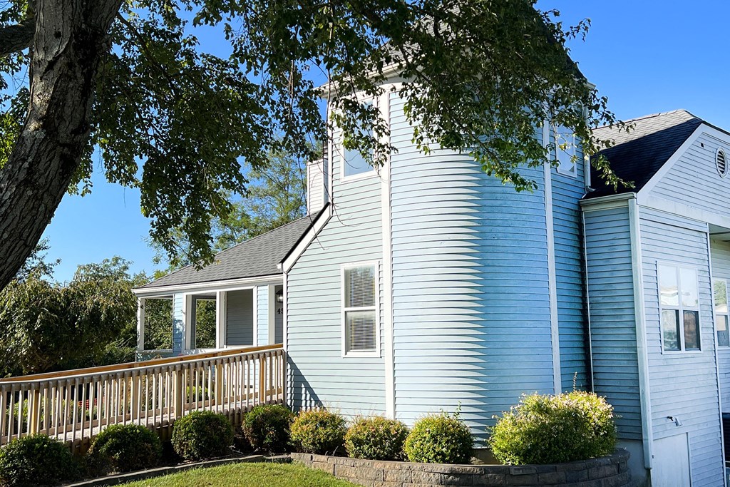 a large blue house with a large tree in front of it at 450 on Keeneland, Kentucky
